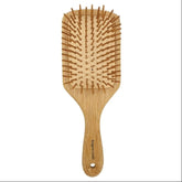 Wooden hairbrush with bristle design on a white background