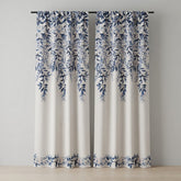 Pair of curtains with blue leaf pattern on a neutral background