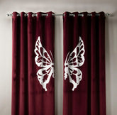 Maroon curtains with white butterfly designs on a neutral background