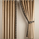 Beige curtains with decorative black patterns on a neutral background