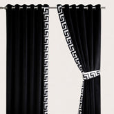 Black curtains with white geometric patterns on a beige background