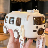 White toy van with brown accents held in a hand, blurred indoor background