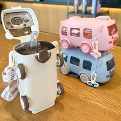 Two novelty items on a wooden surface, one resembling a robot and the other a camper van.