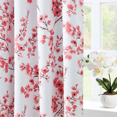 Floral patterned curtains with a window and plant in the background