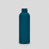 Teal water bottle on a light gray background