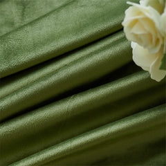 Stack of green fabric with a white rose on a green background