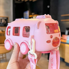 Pink toy car with a lanyard held by a hand in an indoor setting