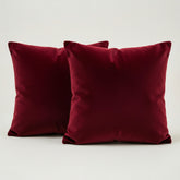 Two red pillows on a light gray background