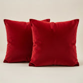 Two red pillows on a beige background
