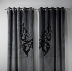 Gray curtains with butterfly cutouts on a plain background