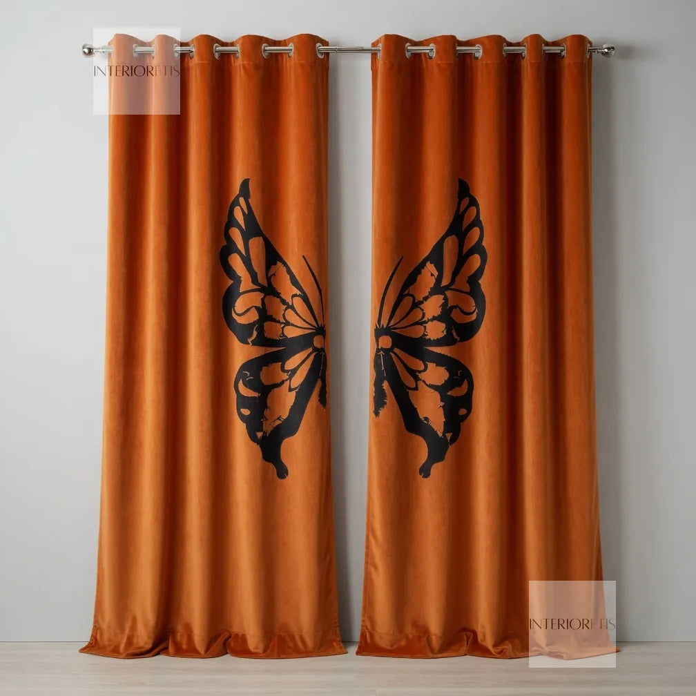Orange curtains with black butterfly designs on a plain background