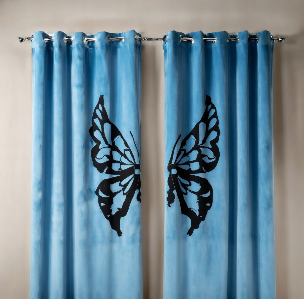 Blue curtains with black butterfly designs on a beige wall