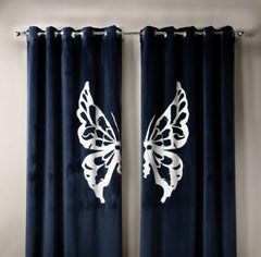 Navy blue curtains with white butterfly designs on a neutral background