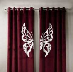 Maroon curtains with white butterfly designs on a neutral background