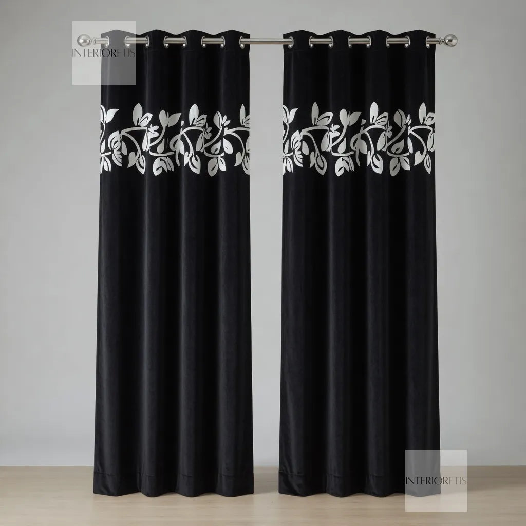 Black curtains with white floral patterns on a gray background