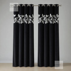 Black curtains with white floral patterns on a gray background