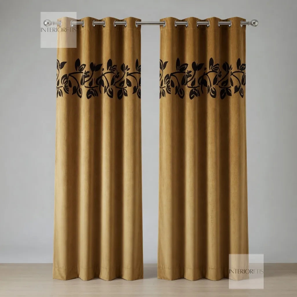 Pair of Golden curtains with black leaf patterns on a neutral background