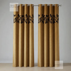 Pair of Golden curtains with black leaf patterns on a neutral background