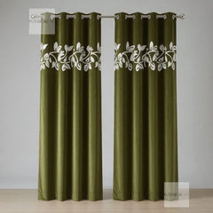 Pair of olive curtains with white floral embroidery on a gray background