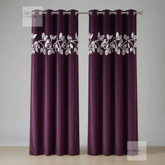 Pair of purple curtains with white floral patterns on a gray background