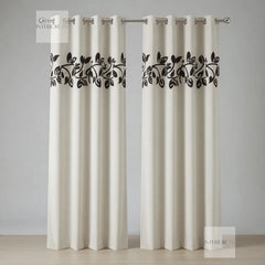 White curtains with black leaf pattern on a gray background