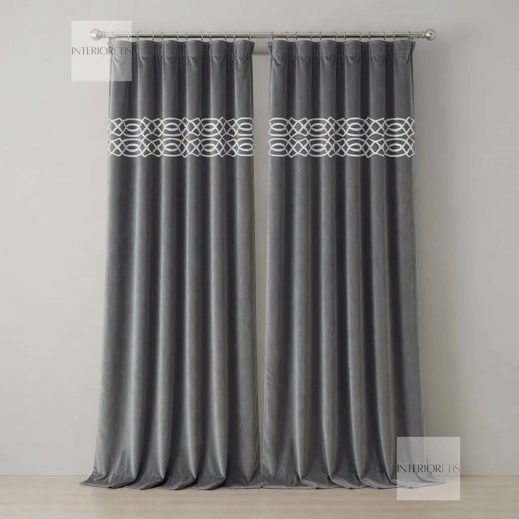 Gray curtain with decorative band on a plain background
