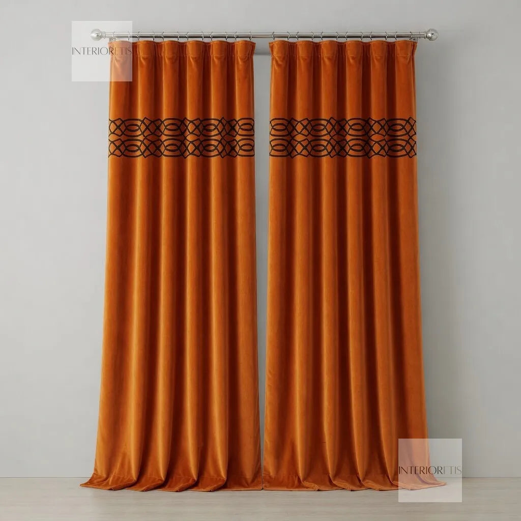 Pair of orange curtains with decorative top panel on a gray background
