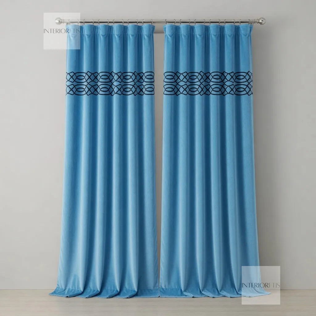 Pair of sky blue curtains with decorative top band on a gray background