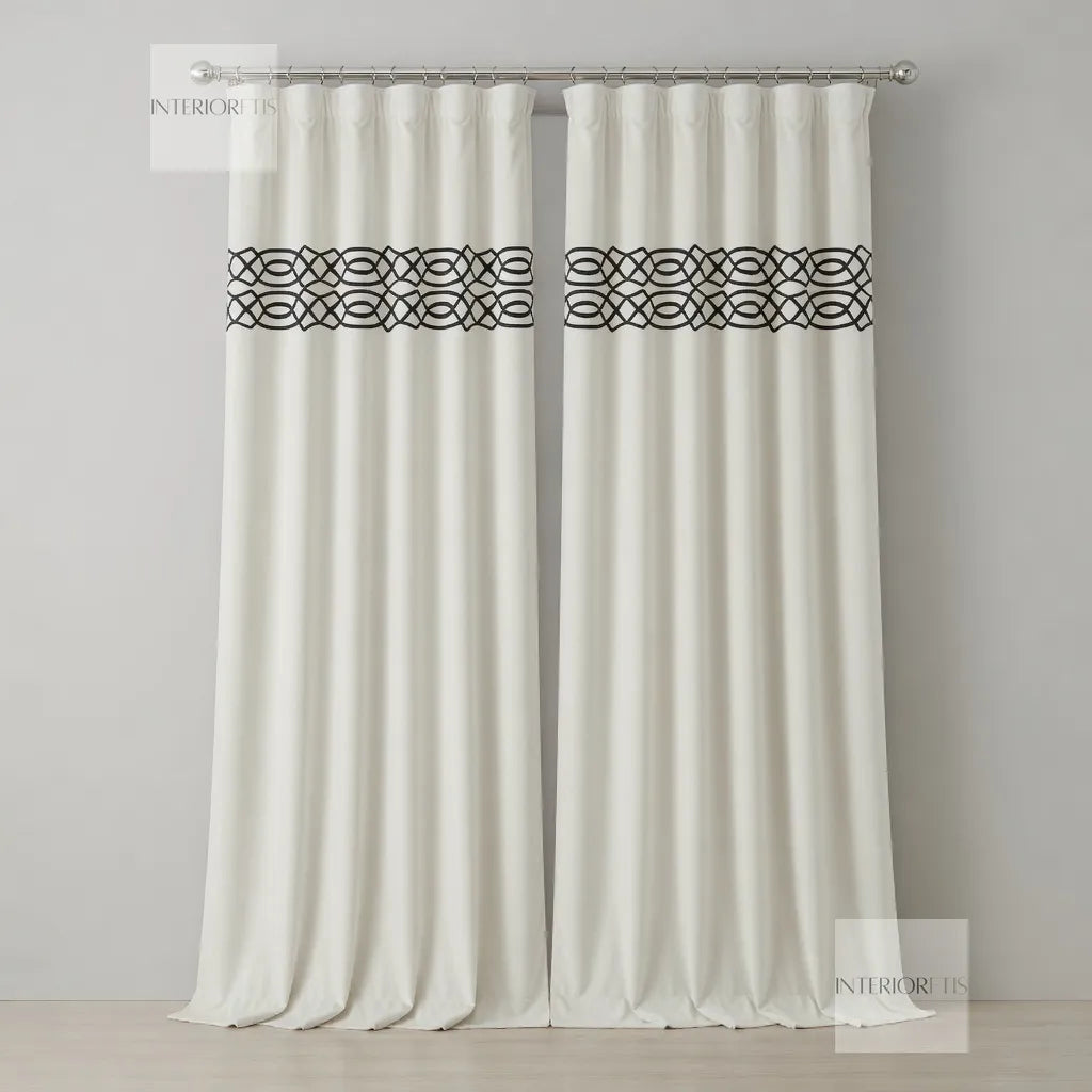 White curtains with black geometric patterns on a gray background