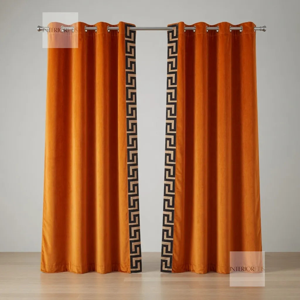 Orange curtains with decorative black patterns on a gray background