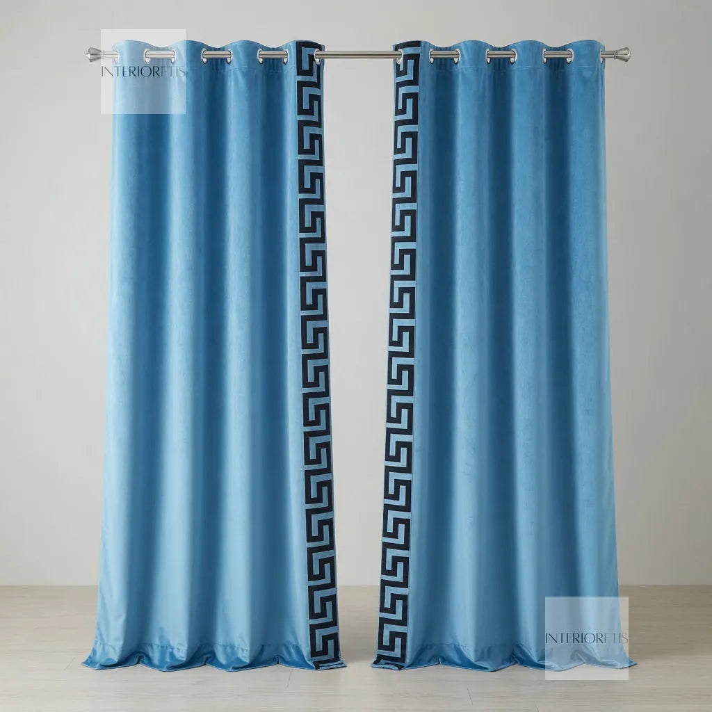 Pair of sky blue curtains with a decorative pattern on a gray background