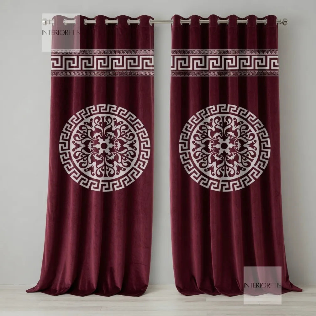 Pair of maroon curtains with white geometric patterns on a plain background