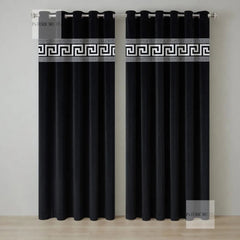 Pair of black curtains with decorative white banding on a neutral background