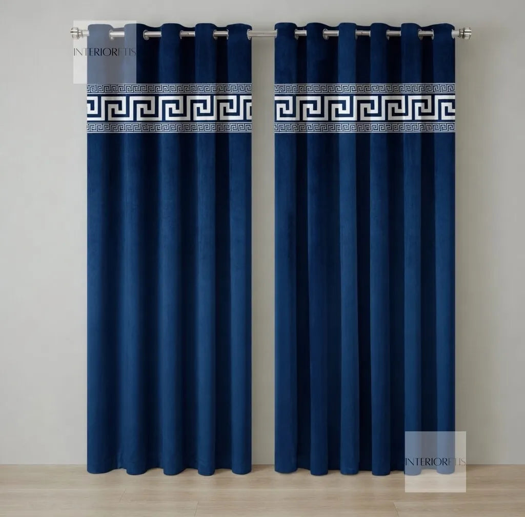 Pair of blue curtains with decorative banding on a plain background