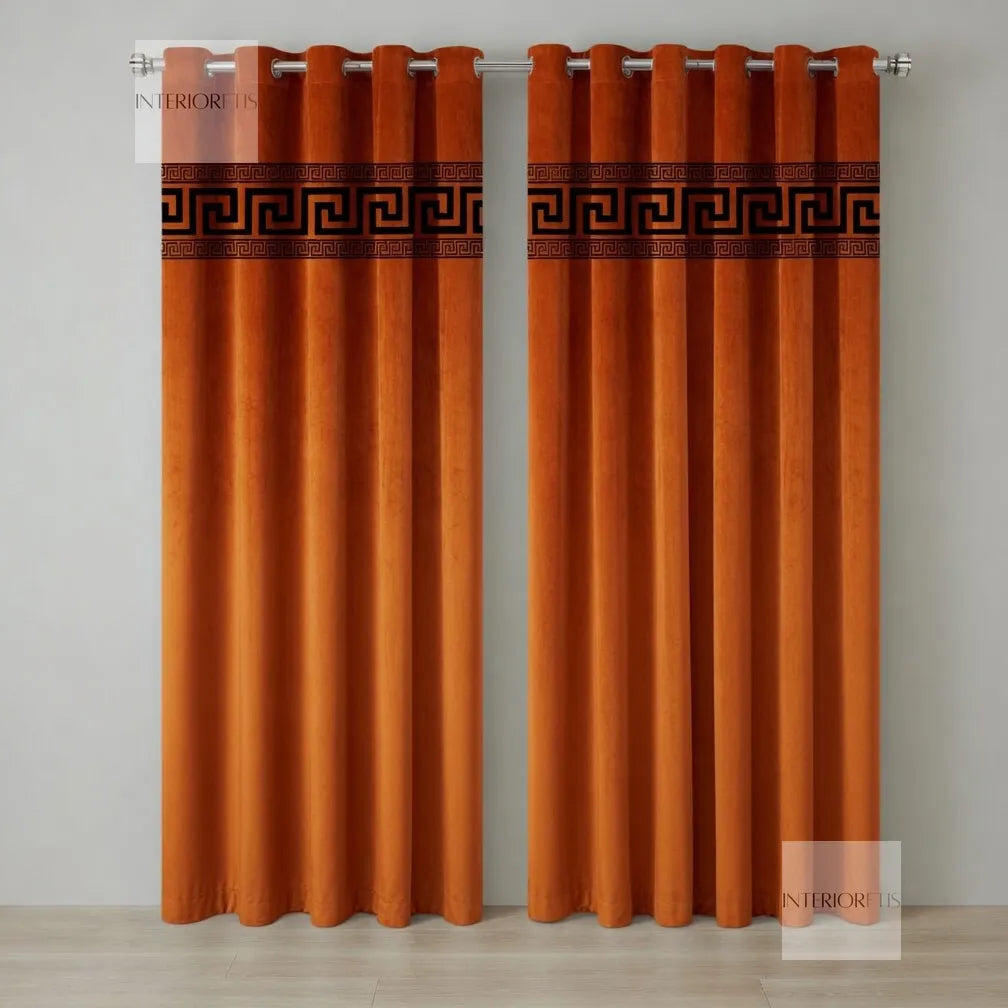 Pair of orange curtains with a decorative band on a gray background