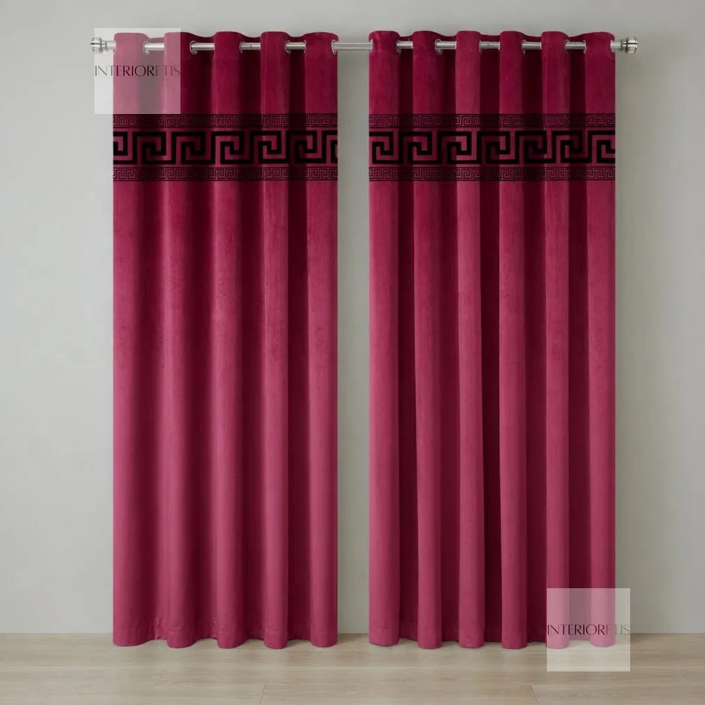 Pair of pink curtains with a decorative black band on a plain background