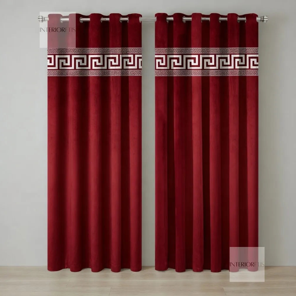 Red curtains with decorative banding on a plain background