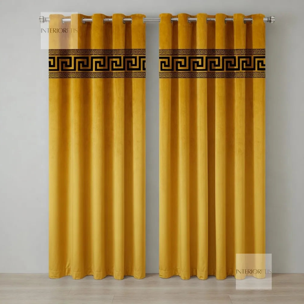 Pair of mustard yellow curtains with decorative banding on a gray background