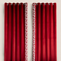 Red curtains with a white geometric pattern on a beige background