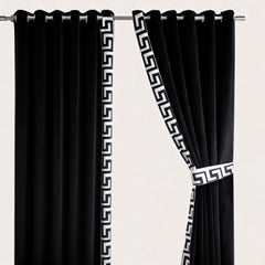Black curtains with white geometric patterns on a beige background