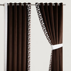 Brown curtains with decorative white patterns on a white background