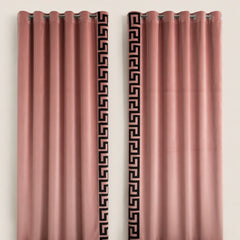 Pair of pink curtains with decorative black patterns on a beige background