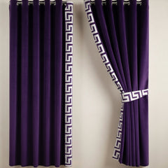Purple curtains with decorative white patterns on a plain background