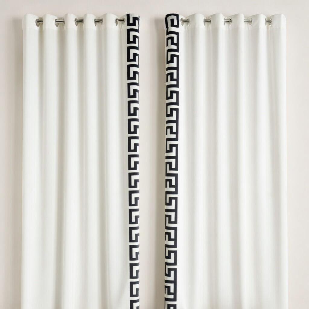 White curtains with black geometric patterns on a plain background