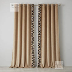 Beige curtains with black geometric patterns on a plain background