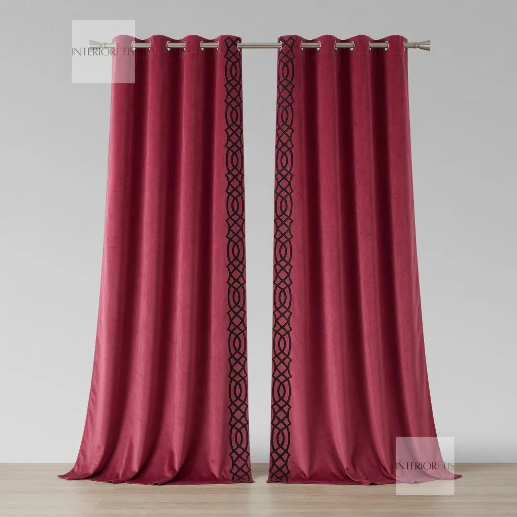 Pink curtains with decorative black patterns on a light gray background