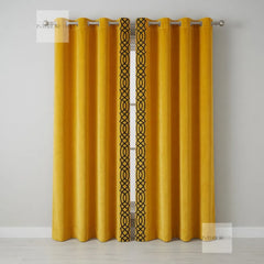 Yellow curtains with black geometric pattern on a gray background