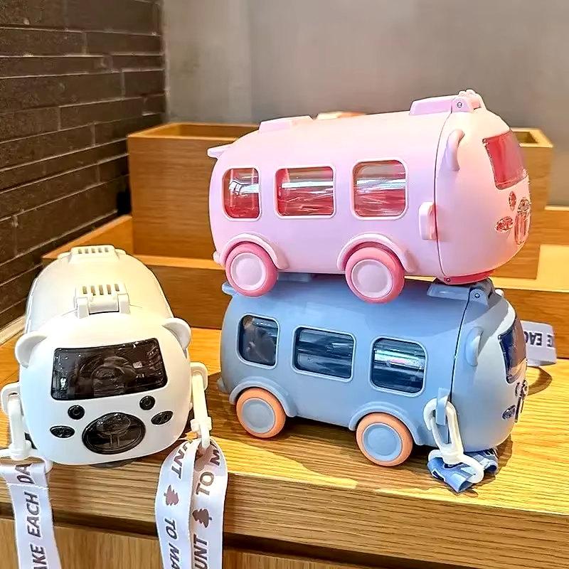 Two colorful robot toys stacked on a wooden surface with a brick wall background.