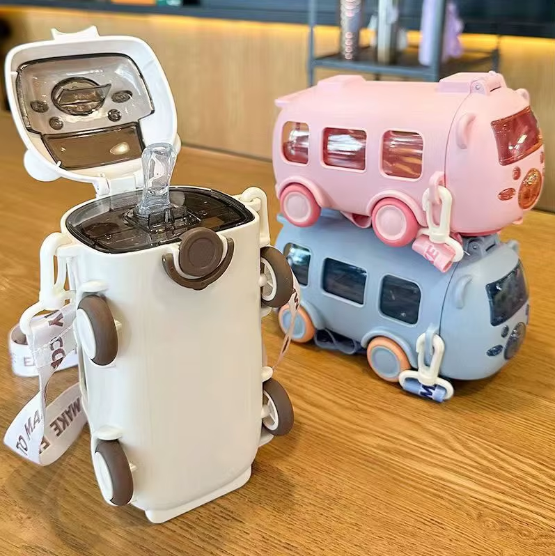 Two novelty items on a wooden surface, one resembling a robot and the other a camper van.