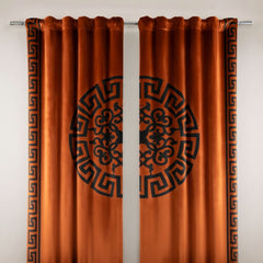Pair of orange curtains with black geometric patterns on a white background